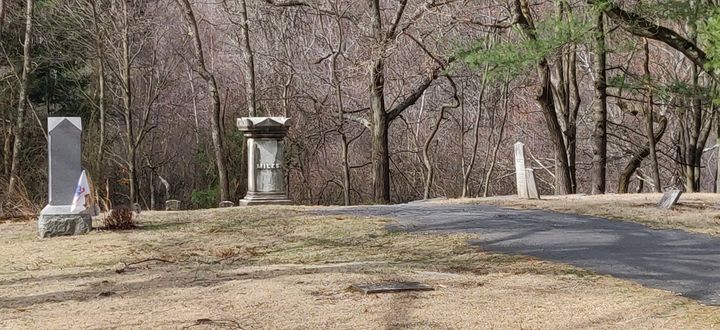 A paved path to a number of old burial monuments.